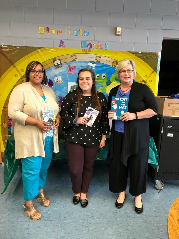 Choctaw County Elementary School librarian and UACED staff showing library books