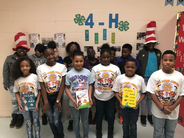 Children at Kinterbish Junior High School, Sumter County showing Dr. Seuss books donated