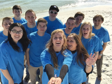 Twelve University of Alabama students taking selfie on beach