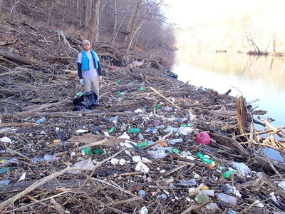 VISTA cleaning up trash on river bank