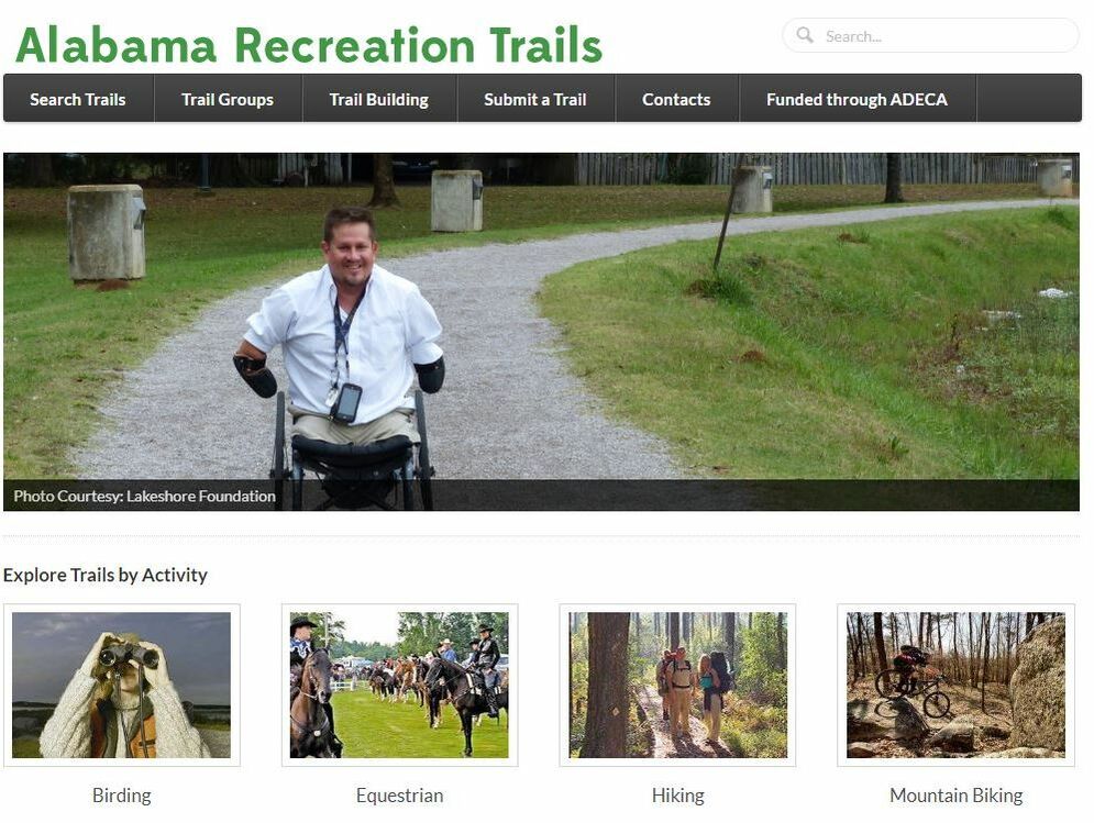 Screen shot of Alabama Recreation Trails website showing man in wheelchair on gravel trail 