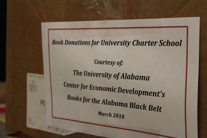 Label on box of books stating Book Donation for University Charter School from UACED March 2018